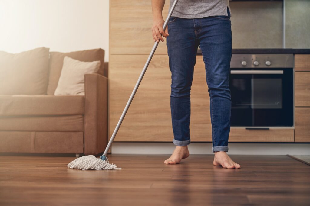 Man washing floor in stylish living room