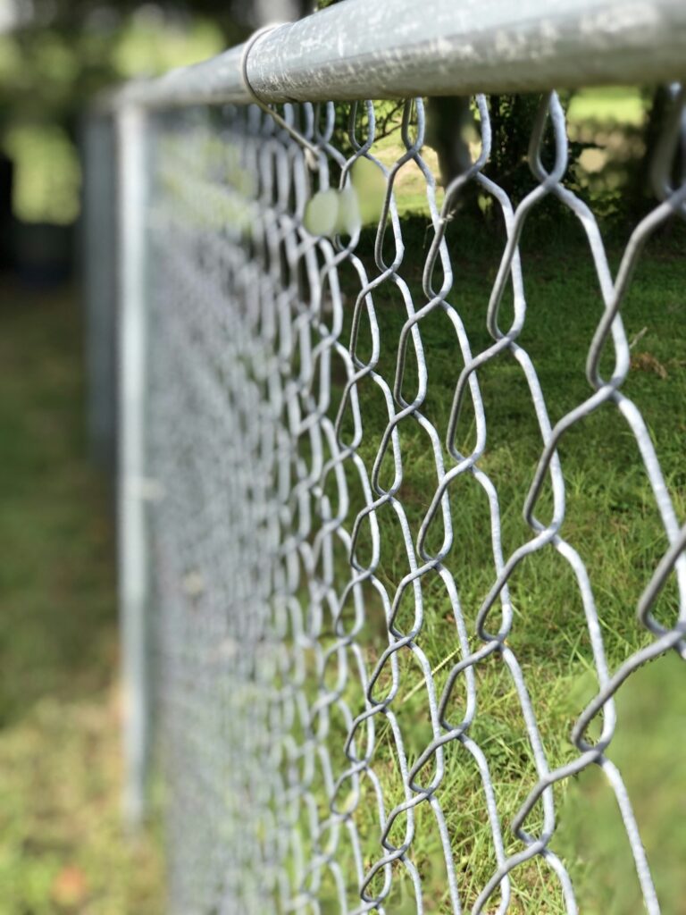 A side view of a metal fence in backyard